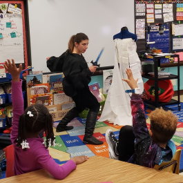 Valerie teaching elementary school kids about costuming