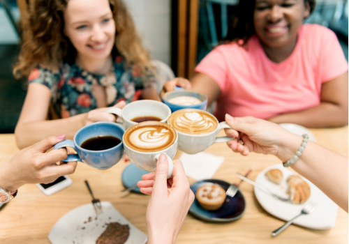Group Coaching image - five women of different ethnicities holding their coffee cups together