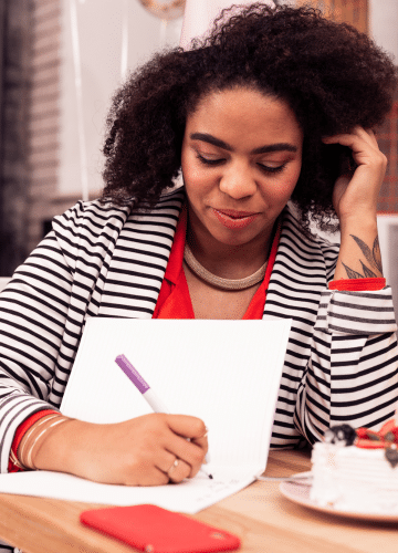 black business woman writing in a journal